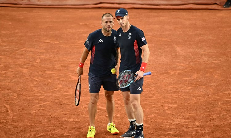 Dan Evans and Andy Murray chatting on court during the Olympics doubles quarter-final